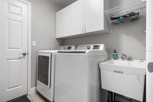 144 Bridgeton St, Davenport, FL 33896 - laundry area with cabinet space and washing machine and clothes dryer