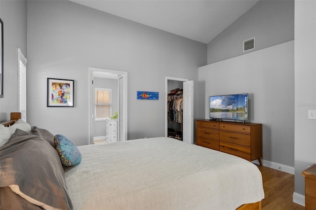 144 Bridgeton St, Davenport, FL 33896 - bedroom with high vaulted ceiling, wood finished floors, a spacious closet, and a closet