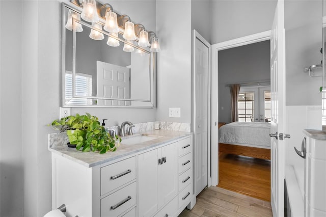 144 Bridgeton St, Davenport, FL 33896 - bathroom with vanity, wood finished floors, ensuite bath, and french doors