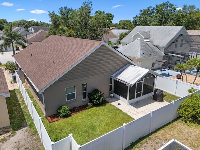 144 Bridgeton St, Davenport, FL 33896 - back of property with a sunroom, a fenced backyard, stucco siding, and a patio