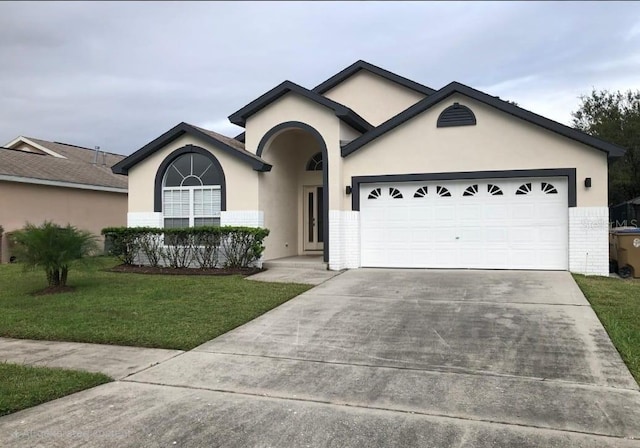 2505 Osprey Creek Ct, Kissimmee, FL 34747 - ranch-style house featuring concrete driveway, stucco siding, a garage, and a front lawn