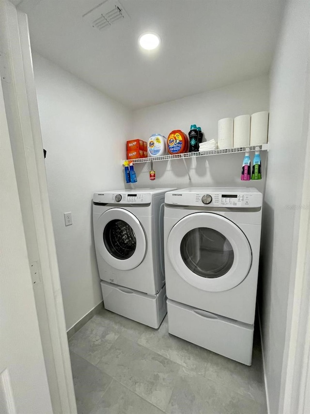 2505 Osprey Creek Ct, Kissimmee, FL 34747 - washroom featuring washing machine and dryer and baseboards
