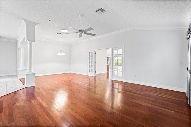 16950 SE 80th Bellavista Cir, The Villages, FL 32162 - unfurnished living room featuring ceiling fan, a textured ceiling, wood finished floors, decorative columns, and ornamental molding