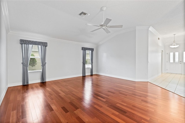 16950 SE 80th Bellavista Cir, The Villages, FL 32162 - unfurnished living room featuring ceiling fan, wood finished floors, vaulted ceiling, and crown molding