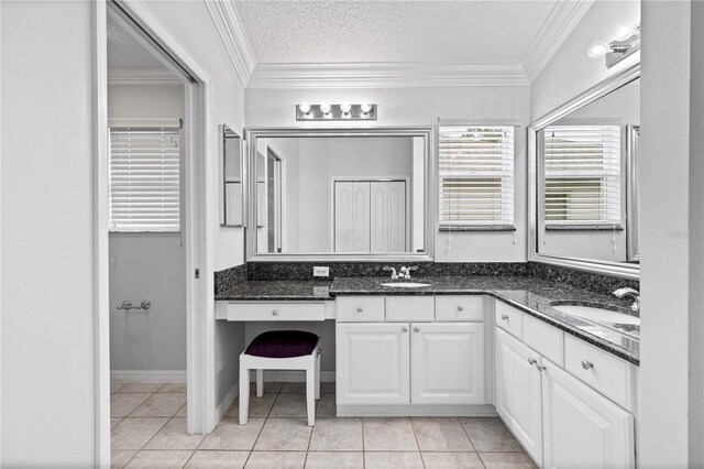 16950 SE 80th Bellavista Cir, The Villages, FL 32162 - bathroom with double vanity, tile patterned floors, crown molding, and a textured ceiling
