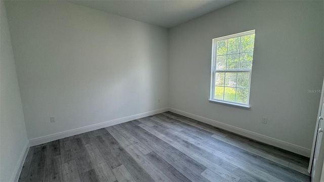 482 Marion Oaks Mnr, Ocala, FL 34473 - unfurnished room with baseboards and wood finished floors