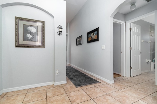 1315 Vista Del Lago Blvd, Dundee, FL 33838 - hallway with arched walkways and light tile patterned floors