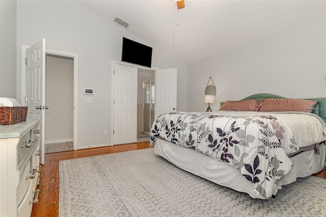 1315 Vista Del Lago Blvd, Dundee, FL 33838 - bedroom with vaulted ceiling, wood finished floors, and a ceiling fan