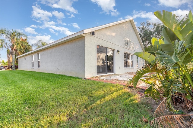 1315 Vista Del Lago Blvd, Dundee, FL 33838 - rear view of house with stucco siding, a yard, and a patio