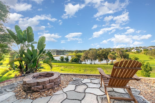 1315 Vista Del Lago Blvd, Dundee, FL 33838 - view of patio / terrace with a fire pit and a water view