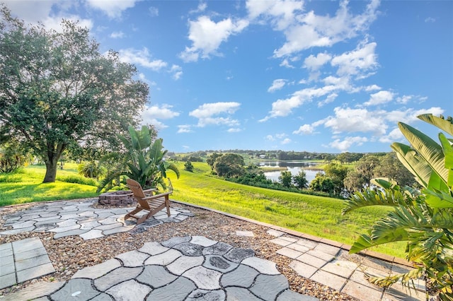 1315 Vista Del Lago Blvd, Dundee, FL 33838 - view of patio with a fire pit and a water view