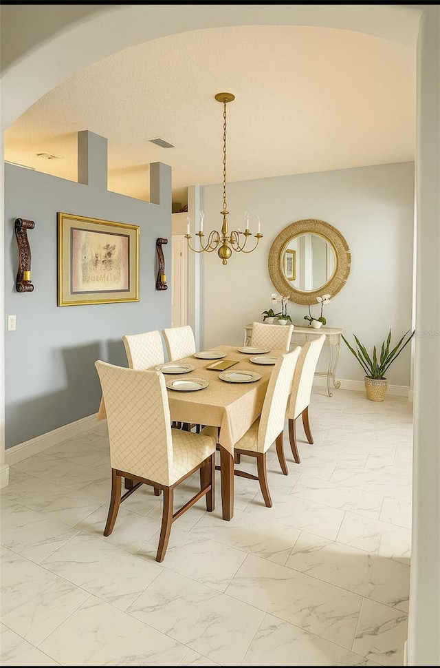 1784 Providence Blvd, Deltona, FL 32725 - dining room with light marble finish flooring, a chandelier, and arched walkways