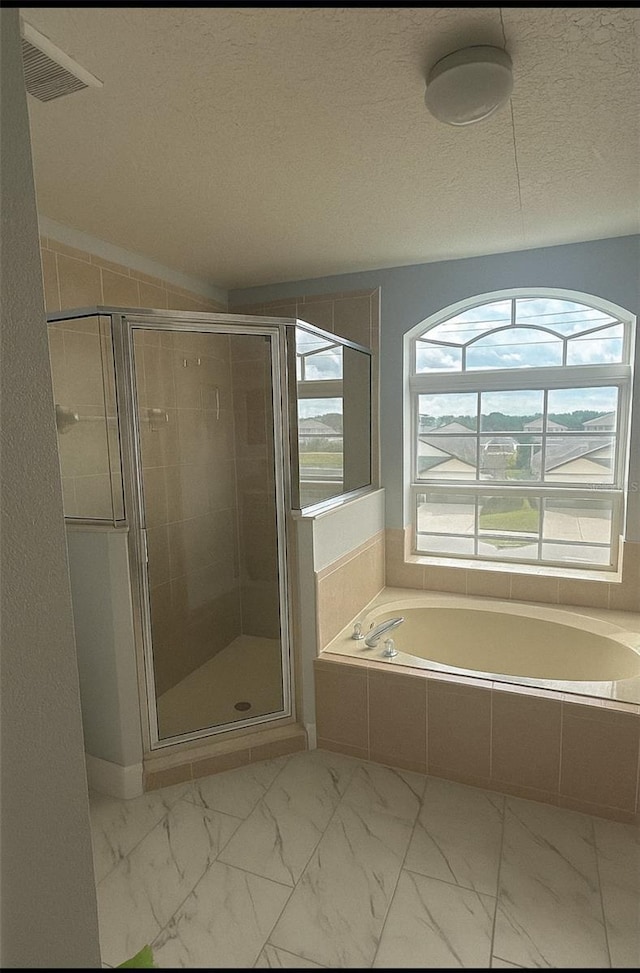 1784 Providence Blvd, Deltona, FL 32725 - full bath with a bath, a stall shower, marble look tile flooring, and a textured ceiling
