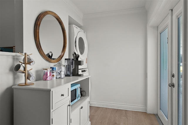 402 S Orlando Ave, Cocoa Beach, FL 32931 - bathroom with stacked washer and clothes dryer, wood finished floors, crown molding, and vanity