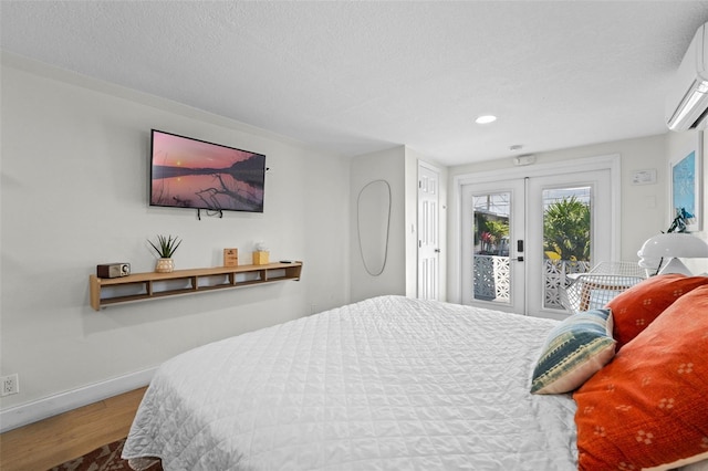 402 S Orlando Ave, Cocoa Beach, FL 32931 - bedroom featuring french doors, access to outside, wood finished floors, a wall mounted air conditioner, and recessed lighting