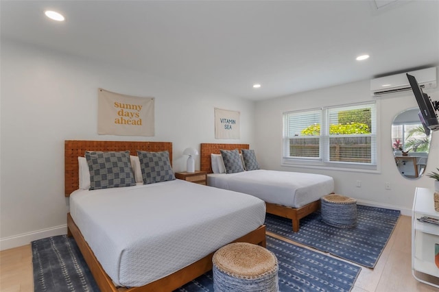 402 S Orlando Ave, Cocoa Beach, FL 32931 - bedroom featuring an AC wall unit, recessed lighting, and wood finished floors