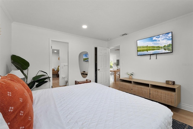 402 S Orlando Ave, Cocoa Beach, FL 32931 - bedroom with wood finished floors, crown molding, recessed lighting, and connected bathroom