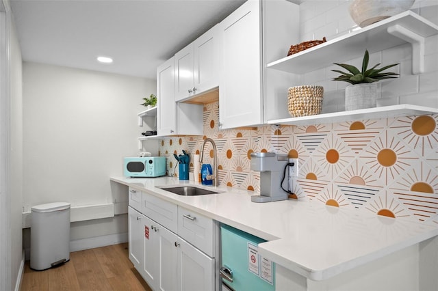 402 S Orlando Ave, Cocoa Beach, FL 32931 - kitchen featuring open shelves, white microwave, recessed lighting, light countertops, and light wood-style floors