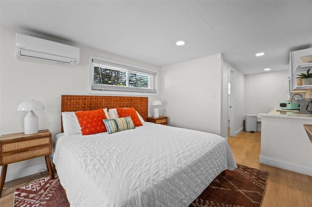 402 S Orlando Ave, Cocoa Beach, FL 32931 - bedroom with a wall unit AC, light wood-style flooring, and recessed lighting