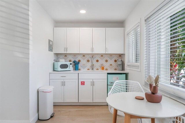 402 S Orlando Ave, Cocoa Beach, FL 32931 - kitchen with backsplash, plenty of natural light, light wood-style flooring, and recessed lighting
