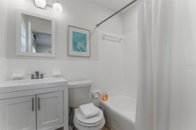 402 S Orlando Ave, Cocoa Beach, FL 32931 - bathroom with vanity, shower / tub combo with curtain, tile walls, and a wainscoted wall
