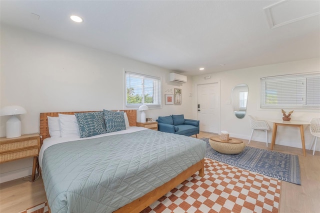 402 S Orlando Ave, Cocoa Beach, FL 32931 - bedroom with a wall mounted air conditioner, light wood-style flooring, and recessed lighting
