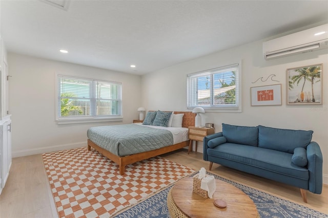 402 S Orlando Ave, Cocoa Beach, FL 32931 - bedroom featuring a wall mounted air conditioner, multiple windows, light wood-type flooring, and recessed lighting