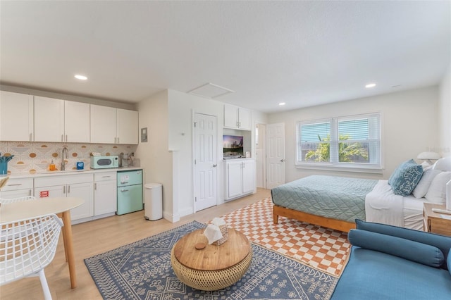402 S Orlando Ave, Cocoa Beach, FL 32931 - bedroom featuring freestanding refrigerator, recessed lighting, and light wood-style floors