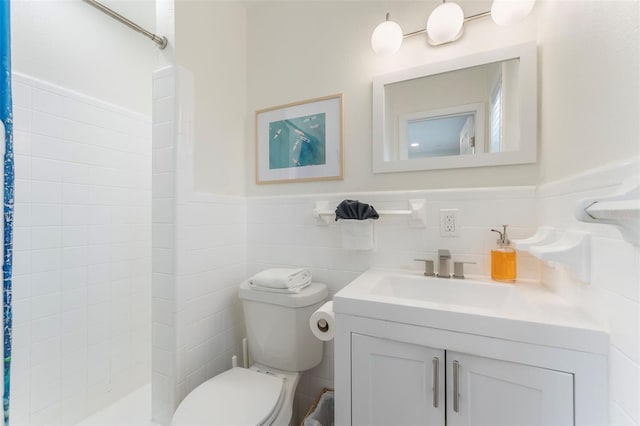 402 S Orlando Ave, Cocoa Beach, FL 32931 - full bathroom with tiled shower, vanity, wainscoting, and tile walls