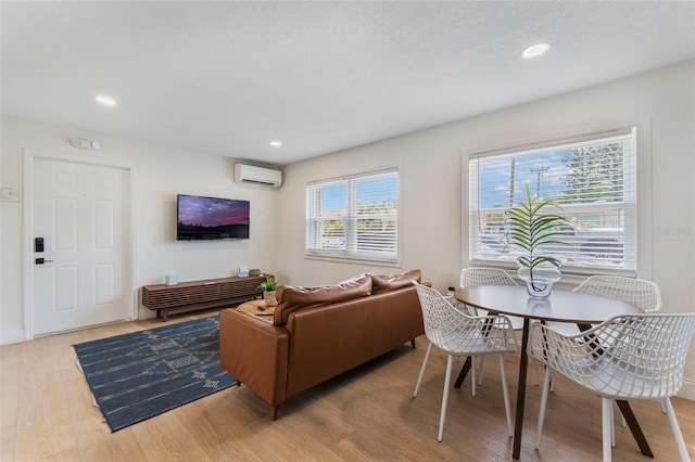 402 S Orlando Ave, Cocoa Beach, FL 32931 - living area featuring an AC wall unit, wood finished floors, and recessed lighting