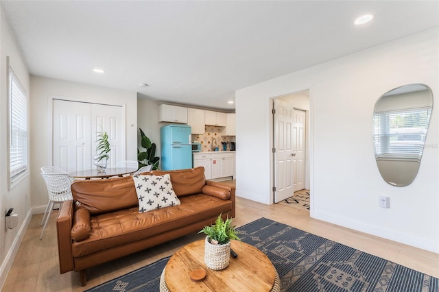 402 S Orlando Ave, Cocoa Beach, FL 32931 - living room with light wood finished floors and recessed lighting