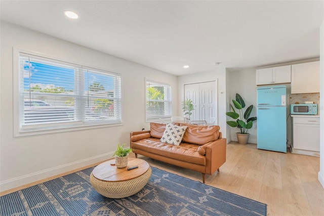 402 S Orlando Ave, Cocoa Beach, FL 32931 - living room featuring light wood finished floors and recessed lighting