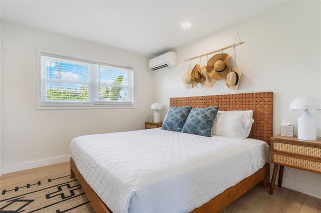 402 S Orlando Ave, Cocoa Beach, FL 32931 - bedroom with a wall mounted air conditioner, light wood-type flooring, and recessed lighting