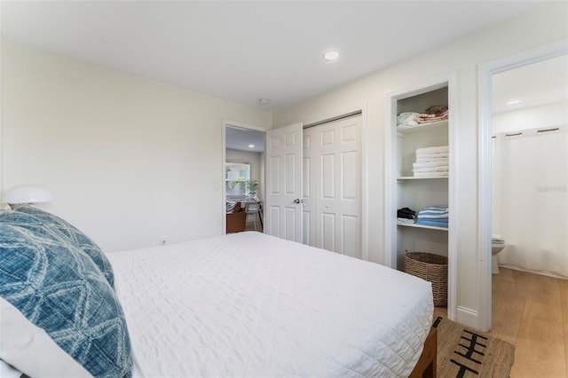402 S Orlando Ave, Cocoa Beach, FL 32931 - bedroom with wood finished floors, recessed lighting, ensuite bathroom, and a closet
