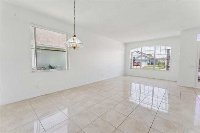 2110 Mallard Creek Cir, Kissimmee, FL 34743 - tiled spare room with healthy amount of natural light and a chandelier