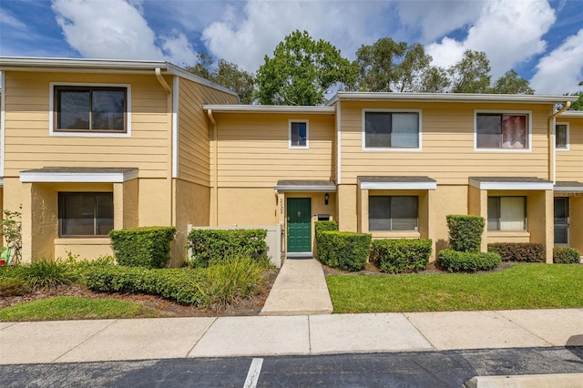 2208 Mcmahon Ct Unit 1033, Orlando, FL 32812 - view of property with stucco siding and uncovered parking