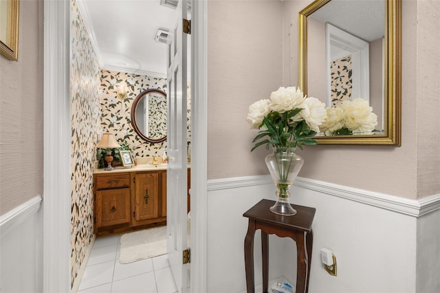 2208 Mcmahon Ct Unit 1033, Orlando, FL 32812 - bathroom featuring wainscoting, vanity, wallpapered walls, tile patterned flooring, and ornamental molding