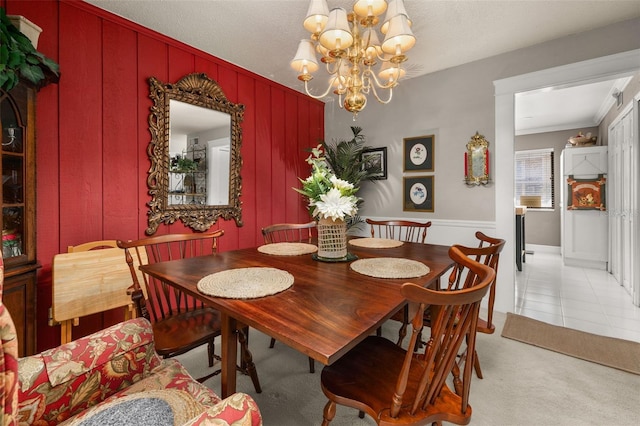 2208 Mcmahon Ct Unit 1033, Orlando, FL 32812 - dining room featuring a chandelier, light colored carpet, light tile patterned floors, and ornamental molding