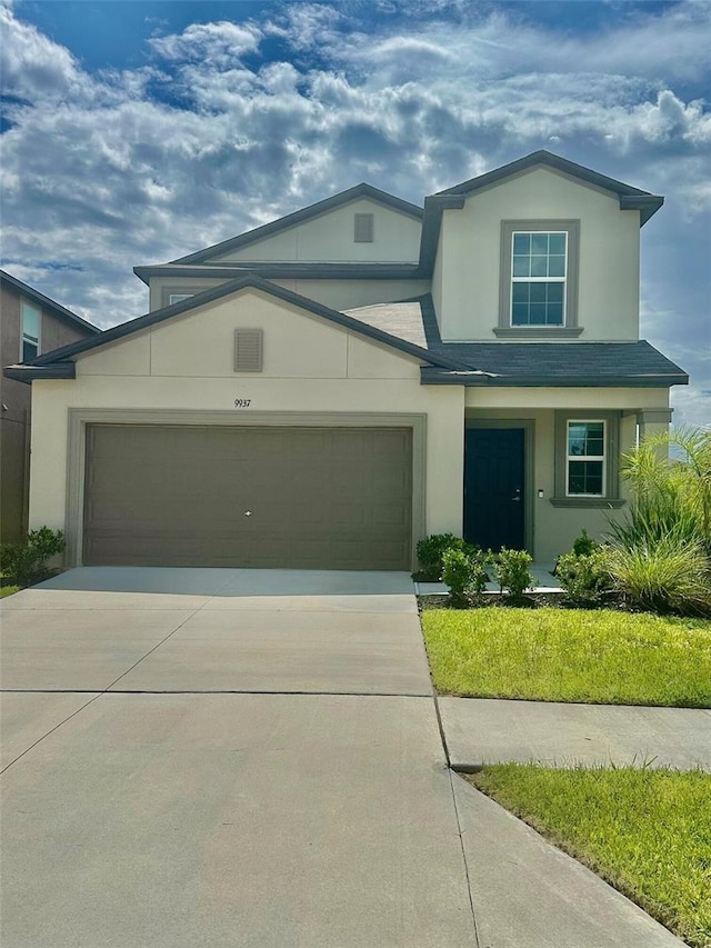 9937 Aqua Miles Path, Wesley Chapel, FL 33545 - view of front of home featuring stucco siding, driveway, and an attached garage