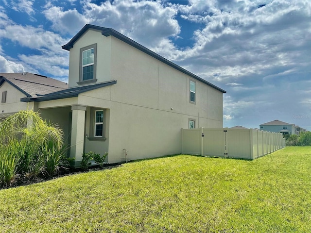 9937 Aqua Miles Path, Wesley Chapel, FL 33545 - view of property exterior with stucco siding and a gate