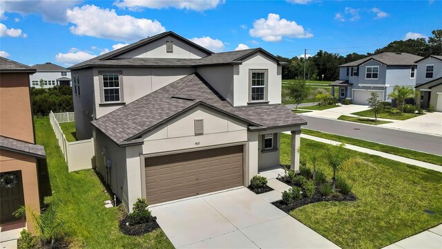 9937 Aqua Miles Path, Wesley Chapel, FL 33545 - view of front of property with stucco siding, a shingled roof, concrete driveway, and a residential view