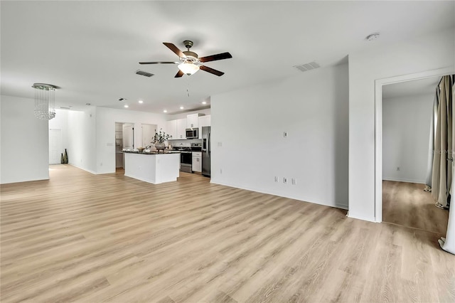 9937 Aqua Miles Path, Wesley Chapel, FL 33545 - unfurnished living room featuring ceiling fan, light wood-style floors, and recessed lighting