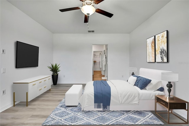 9937 Aqua Miles Path, Wesley Chapel, FL 33545 - bedroom featuring light wood finished floors, a ceiling fan, and ensuite bath