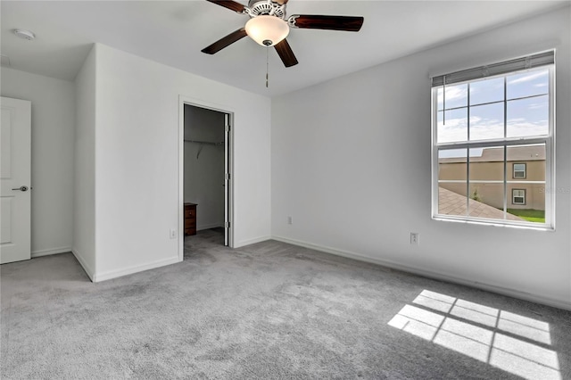 9937 Aqua Miles Path, Wesley Chapel, FL 33545 - unfurnished bedroom with carpet flooring, a walk in closet, a closet, and a ceiling fan