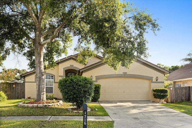 1716 Westerly Dr, Brandon, FL 33511 - view of front of house featuring an attached garage, driveway, stucco siding, and brick siding