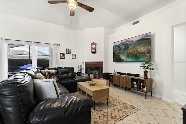 1716 Westerly Dr, Brandon, FL 33511 - living room with a ceiling fan, light tile patterned floors, and a glass covered fireplace