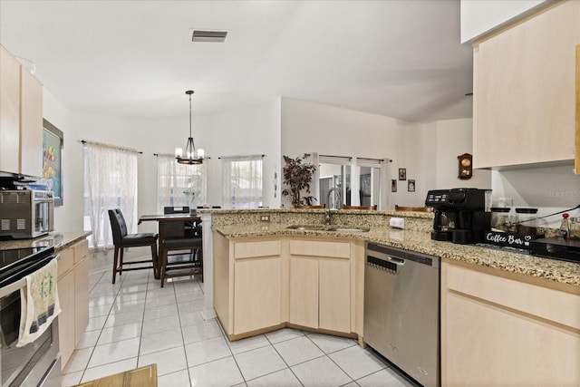 1716 Westerly Dr, Brandon, FL 33511 - kitchen featuring appliances with stainless steel finishes, light brown cabinets, a peninsula, a chandelier, and light stone counters