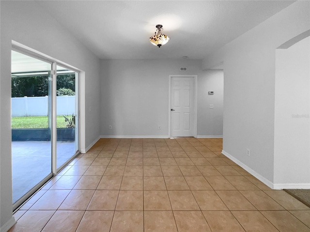 16006 Stags Leap Dr, Lutz, FL 33559 - spare room with arched walkways and light tile patterned flooring