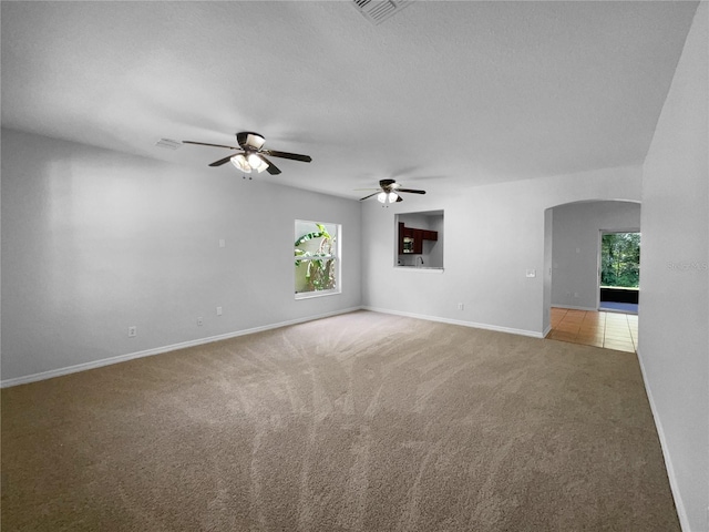 16006 Stags Leap Dr, Lutz, FL 33559 - empty room featuring light carpet, a ceiling fan, and arched walkways