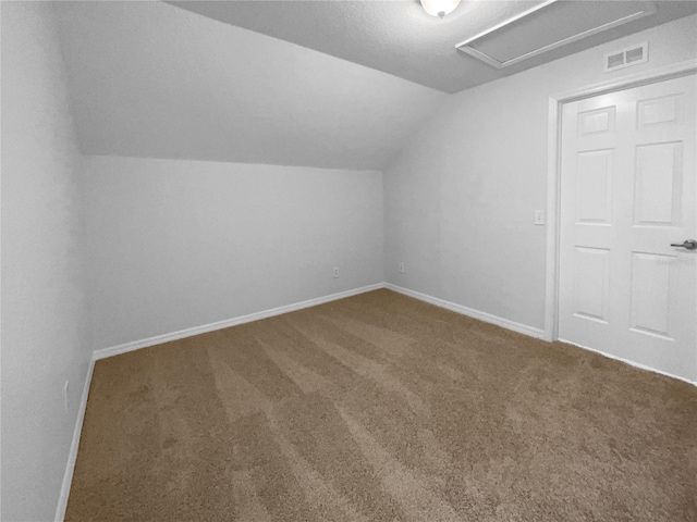 16006 Stags Leap Dr, Lutz, FL 33559 - additional living space with lofted ceiling, carpet flooring, and attic access